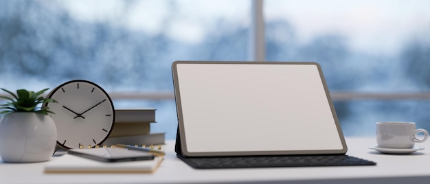 Workspace tabletop with digital tablet mockup with wireless keyboard over blurred background