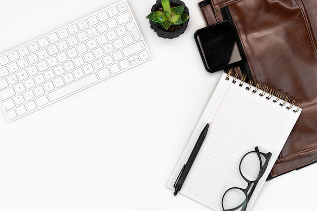 Workspace with coffee and green plant