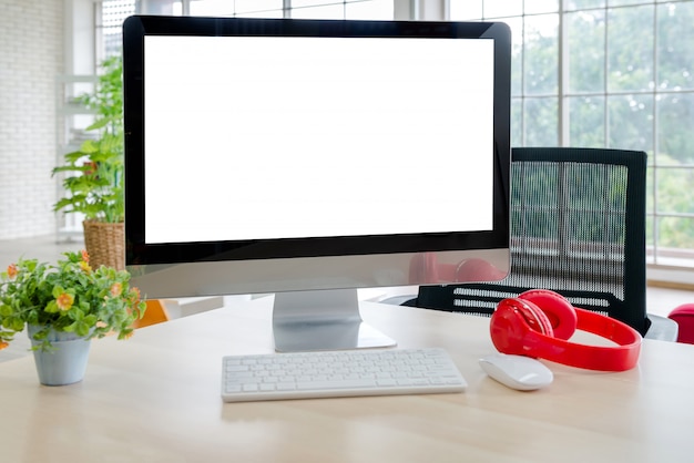 Workspace with monitor, keyboard and headphones