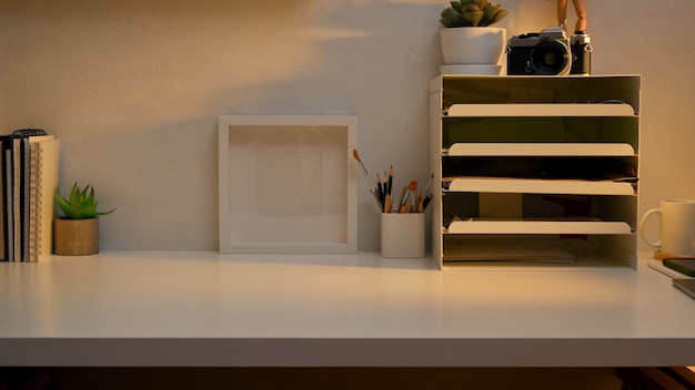 Workspace with stationery, office paper filing trays, decorations and copy space in home office room