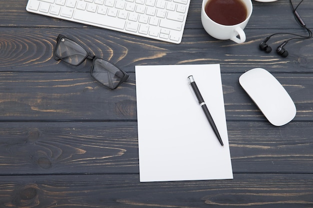 Workspace with tablet keyboard coffee cup and eyeglasses copy space on background Top view