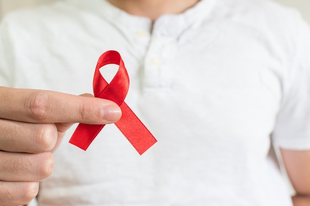 World Aids Day hand with red ribbon symbol