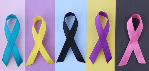 World cancer day Colorful awareness ribbons on different color background