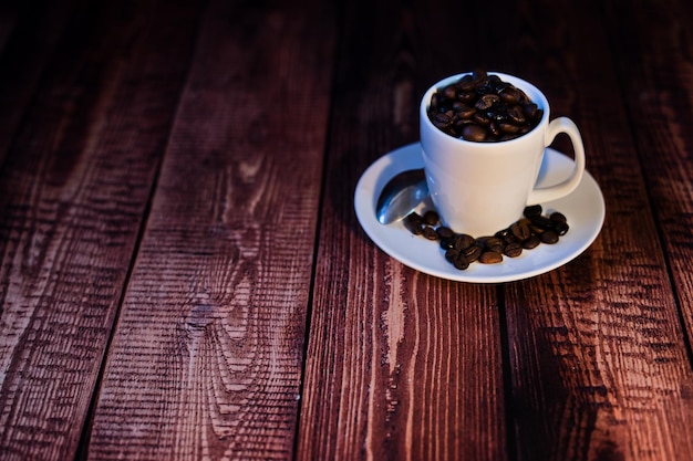 World coffee day concept white porcelain cup with coffee beans