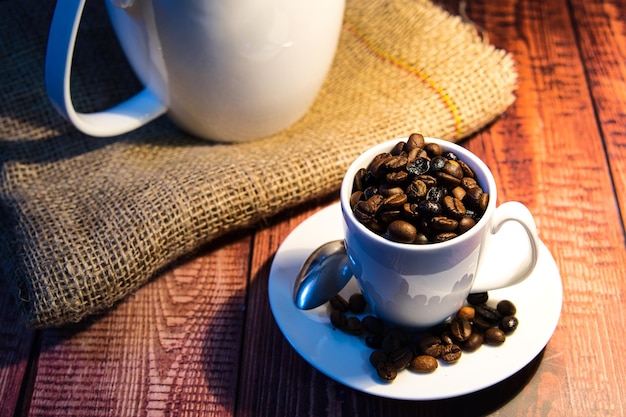 World coffee day concept white porcelain cup with coffee beans