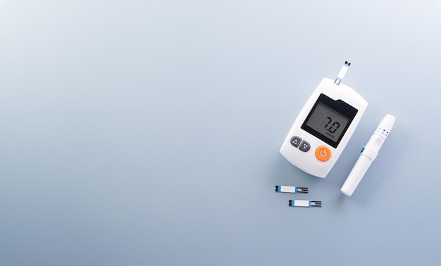 World Diabetes day concept 14 November Top view of blood glucose meter sets on pastel blue background