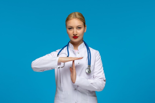 World doctors day focused cute doctor showing stop sign with the stethoscope in the medical coat