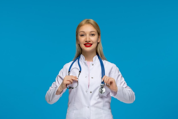 World doctors day happy blonde young doctor with the stethoscope in the lab