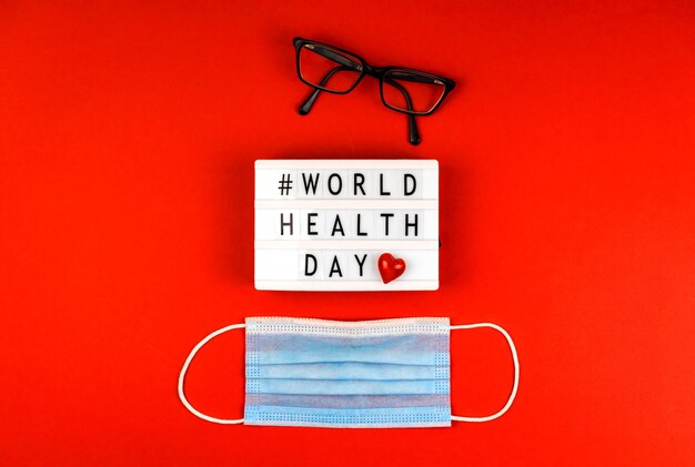 World health day concept background with text message medical mask and one red heart