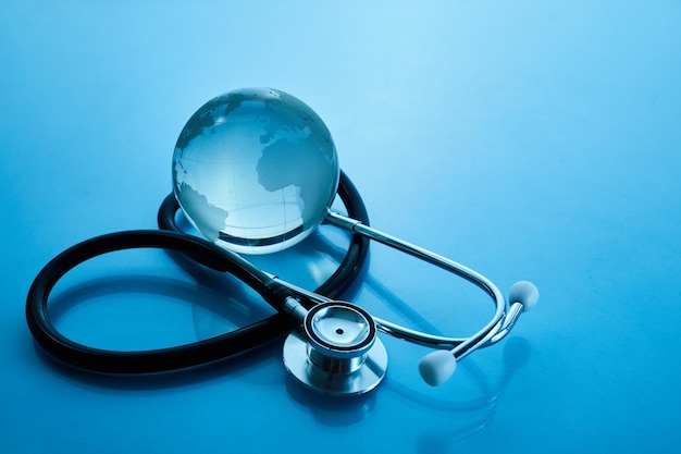 World health day global health awareness concept globe and stethoscope on blue background