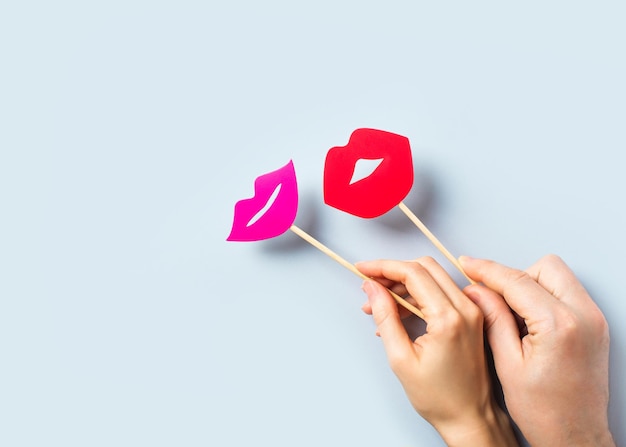 World kissing day concept with lips on stick on blue background