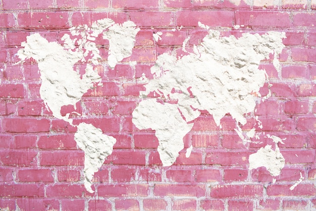 World map of white cement plaster on a pink brick background. Pink Brick grunge wall