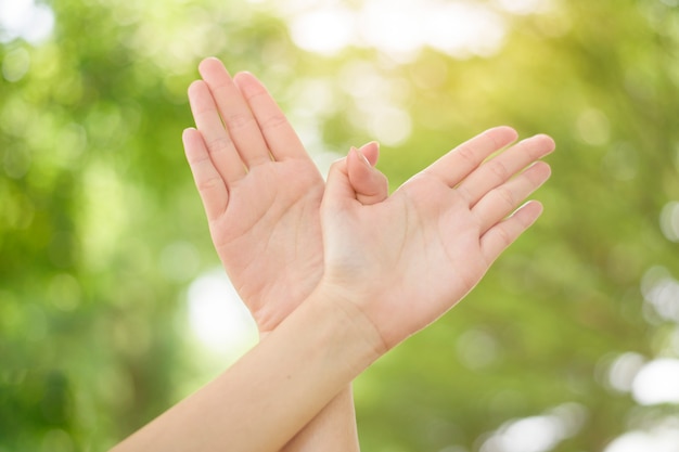 World peace Day , human hand on green background