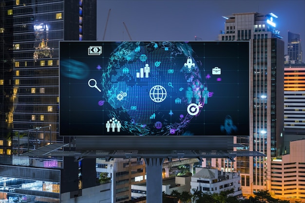 World planet Earth map hologram and social media icons on billboard over night panoramic city view of Bangkok Southeast Asia Networking and establishing new connections between people Globe