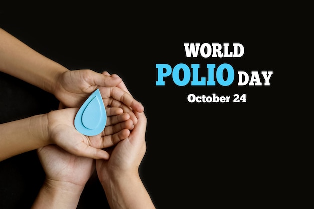 World Polio day October 24 Blue drop in hands of an adult and child is symbol of polio vaccine