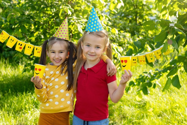 World Smile Day children's friendship different emotions on paper cups