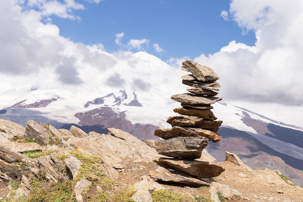 World tourism day, pyramid of stones on the slope of mount Cheget