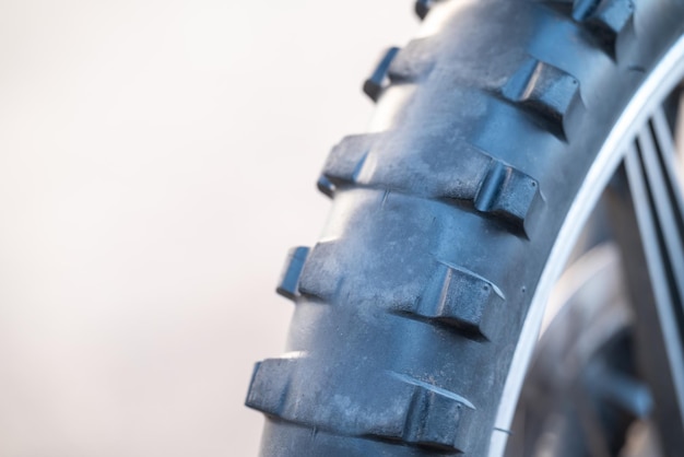 Worn tires on Enduro motorcycle close up copy space on the left