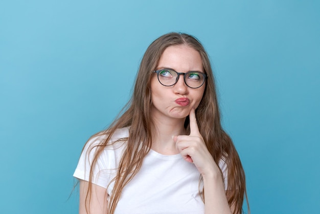 Worried stupid and insecure young woman with long hair nervous fingers in alarm