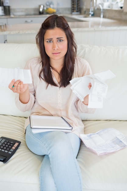 Worried woman calculating finances