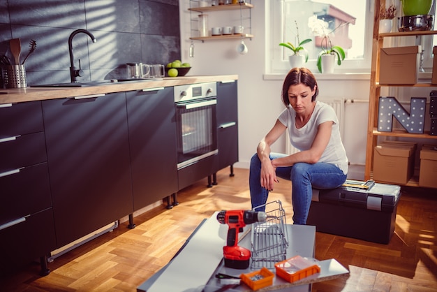 Worried woman renovating kitchen