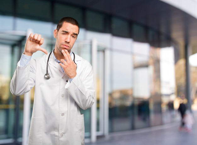 Worried young doctor with lose gesture