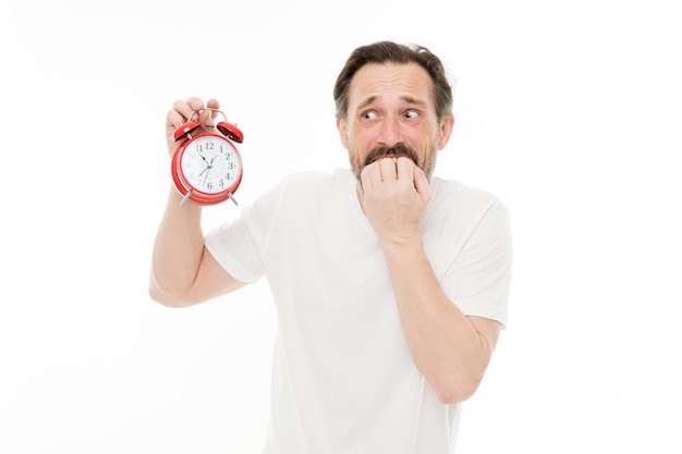 Worry about time Personal schedule and daily regime Alarm clock morning time Man bearded mature guy hold clock isolated on white Man with beard check what time is it Time management skills