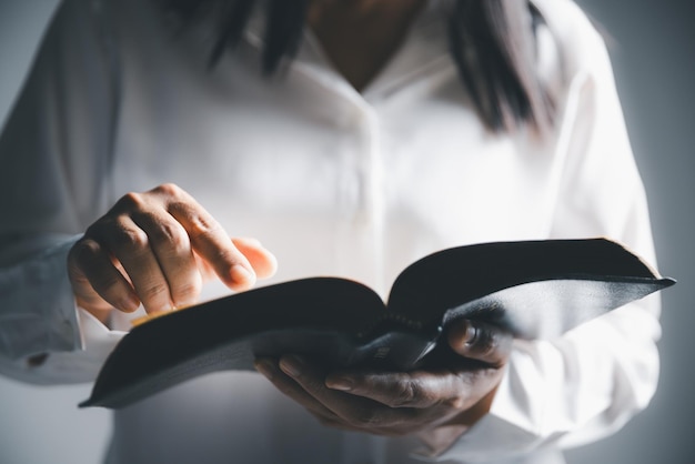 Worship christian with bible concept Young woman person hand holding holy bible with study at home Adult female christian reading book in church Girl learning religion spirituality and pray to god