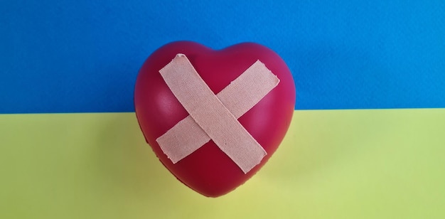 Wounded heart with bandaid and flag of Ukraine