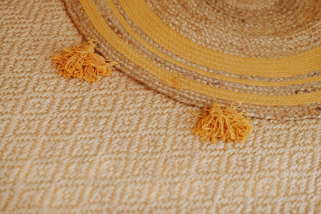 Woven mat with yellow tassels