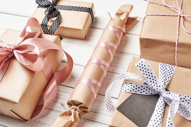 Wrapped gift boxes with ribbon on a white background, close up