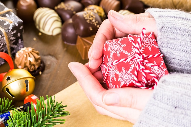 Wrapping assorted chocolates in small boxes for Christmas presents.