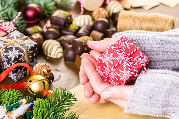 Wrapping assorted chocolates in small boxes for Christmas presents.