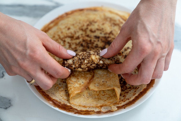 Wrapping the curd filling into a fried pancake