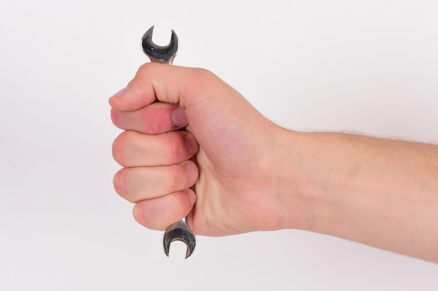 Photo wrench tool in male hand isolated on white background