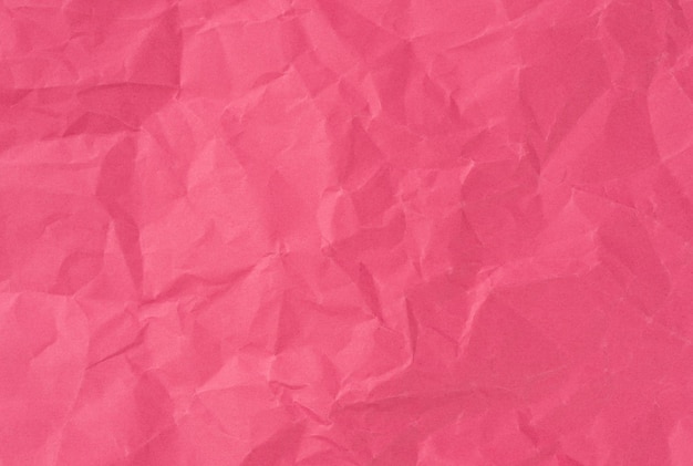 Wrinkled sheet of pink paper Textured backdrop