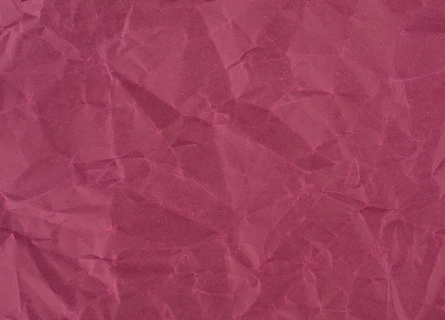 Wrinkled sheet of wine red paper Textured backdrop