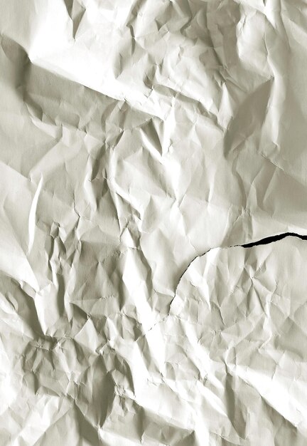 Wrinkled and torn white paper Textured paper background with copy space Top view