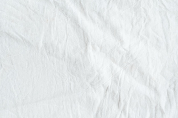 Wrinkled white cotton fabric texture background, wallpaper