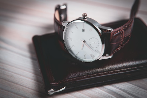 Wrist watch and wallet on the table