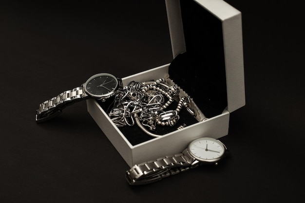 Wristwatch with metal strap on black background