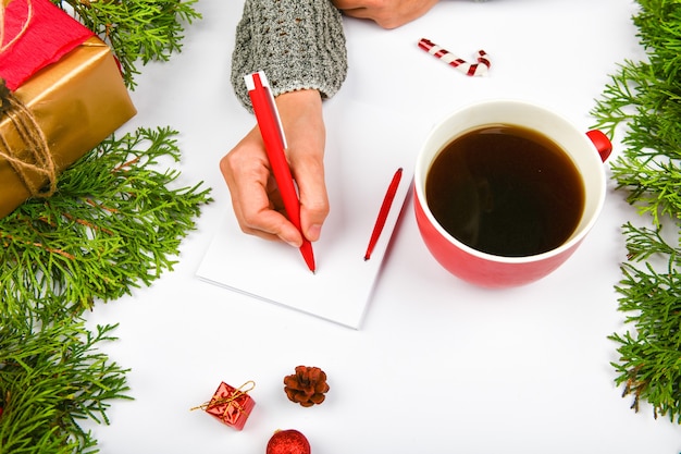 Writes wishes with a coffee mug