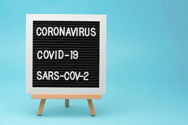 Writing board CORONAVIRUS COVID19 and SARSCOV2 isolated on blue background