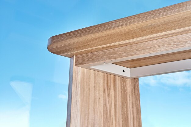 Writing desk made with bleached solid oak timber against the sky outside the window bottom view