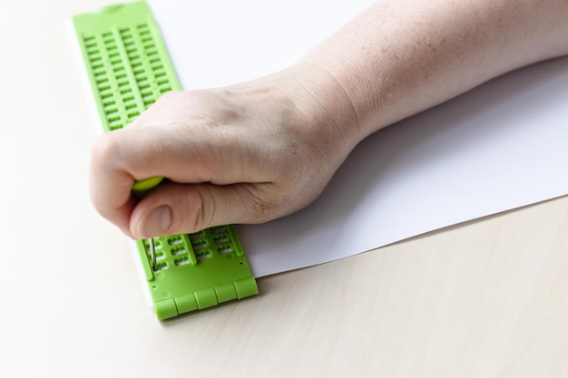 Writing words in braille with slate and stylus