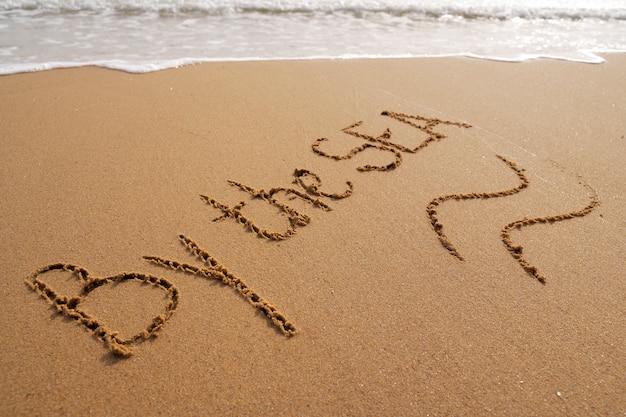 Photo writing words in the sand