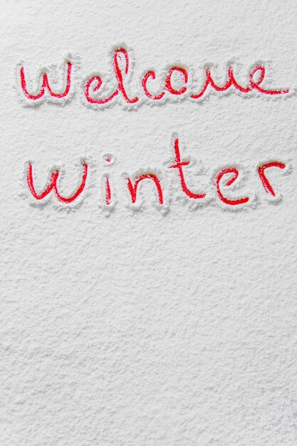 Written Welcome winter on the snowy background