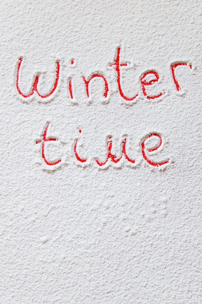 Written Winter time on the snowy backgroun