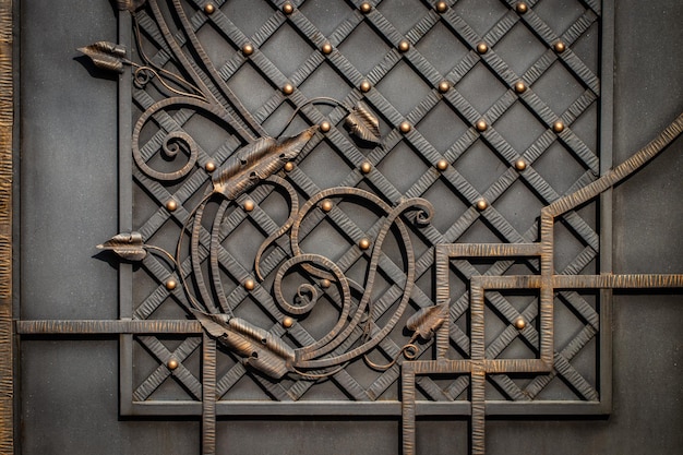 Photo wrought-iron gates, ornamental forging, forged elements close-up.