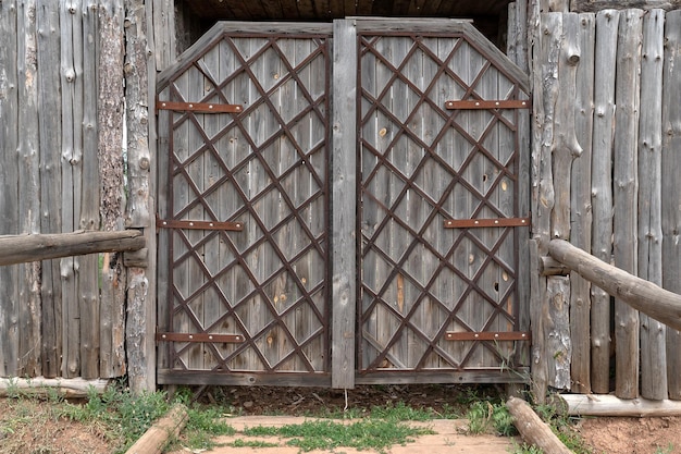 Wrought iron wooden gate Gray fence